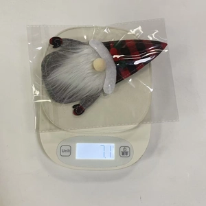 Close-up of a 7.1g Christmas gnome cutlery holder weight measurement on a scale