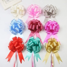 Macro shot of 9 assorted matte metallic pull flower bows for gift and flower decoration