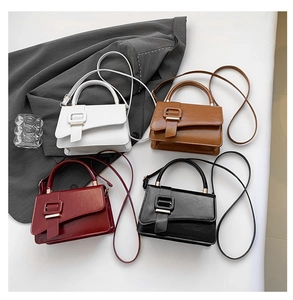 Flat lay of four minimalist PU leather handbags in white brown burgundy and black colors