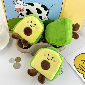 Three cute avocado-shaped plush coin purses with smile design and metal chains in a tray