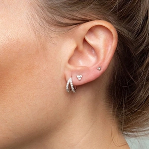 Close-up of S925 silver cross hoop earrings and triangle stud set with pave zircons
