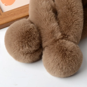 Detail view of brown faux rabbit fur scarf featuring two soft plush pom-poms on the ends