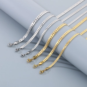 Flat Cuban link chain necklace in gold and silver finish on display stand