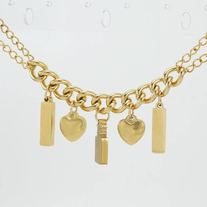 Macro shot of gold-plated stainless steel heart and geometric pendants with polished finish