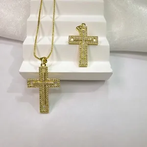 Detailed view of hollow gold cross pendant featuring 18K plating and sparkling white zircon