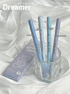 Detailed view of dual-tip fluorescent highlighters in Morandi colors resting on silk