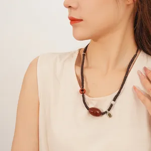 Handmade agate and jade pendant necklace with woven cord in a retro vintage style