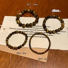 Detail of four tiger eye bead bracelets in 10mm, 8mm, 6mm, and 4mm bead diameters