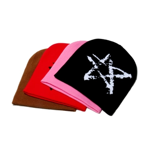 Stacked variety of winter knit beanies in brown, red, pink and black with star pattern