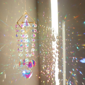 Macro shot of diamond metal frame with heart crystal prism reflecting rainbow light