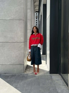 Chic red half-zip sweatshirt with Planta Rosa print styled with denim skirt and heels