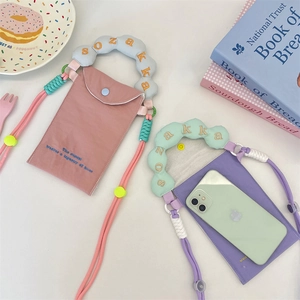 Detailed view of canvas phone bags with cloud-shaped handles and woven straps