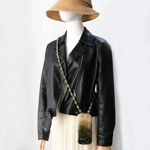 Lifestyle view of a fashion crossbody phone strap with green acrylic beads and a case
