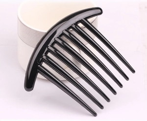 Detail view of a black plastic hair comb clip resting on a white ceramic mug base