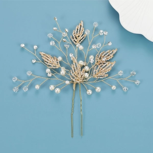 Golden bridal hair pin with crystal leaves and white pearls on blue background