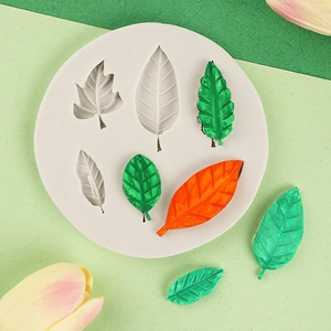 Detailed silicone mold for DIY leaf shapes with green and orange finished resin pieces