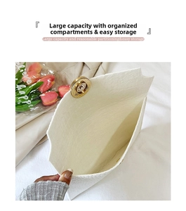 Detailed view of white lychee leather envelope bag with gold magnetic buckle closure