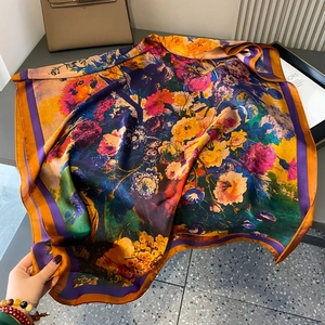Floral print faux silk scarf featuring vibrant yellow and purple patterns with soft drape