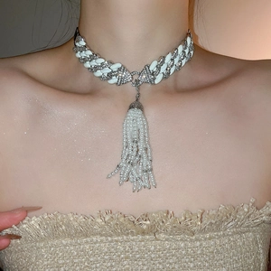 Detailed view of luxury white chain necklace featuring elegant pearl tassel fringe