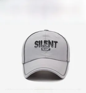 Close-up of black 'SILENT' embroidery on a light gray quick-dry baseball cap