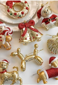 Detail of red and gold glitter Christmas tree ornaments like gingerbread man and bells