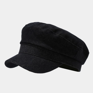 Detailed side view of black denim military cap with a structured flat top and short brim