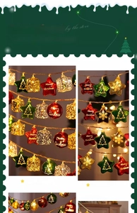 Detail of Christmas LED string lights with red stars, green baubles, and golden gift charms