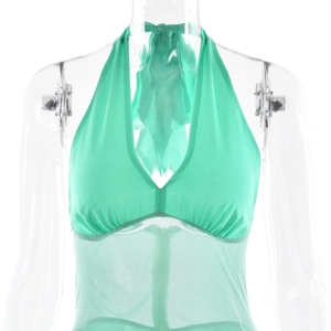 Close-up of green halter neck bodysuit with sheer mesh panels on transparent mannequin