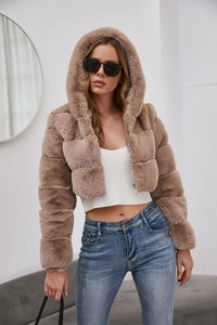 Close-up of mocha faux fur coat featuring square quilted stitching and metal zipper