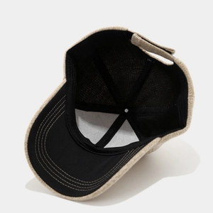 Winter knitted baseball cap in beige and black with adjustable strap and warm fabric