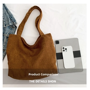 Macro detail of brown corduroy tote bag showing spacious interior and soft fabric texture