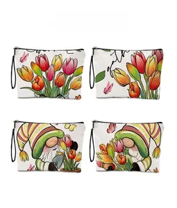 Detailed view of four floral tulip and gnome print waterproof makeup bags with wrist straps