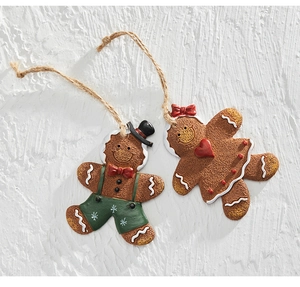 Macro detail of gingerbread man resin ornaments showing realistic icing texture and twine