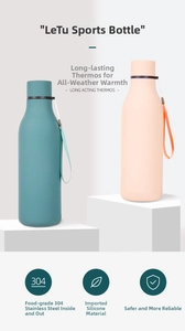 Detail view of matte 304 stainless steel thermos with carry rope on geometric stand