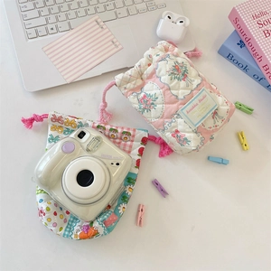 Detailed view of quilted cotton drawstring bags with floral and patchwork patterns