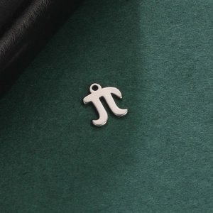 Macro shot of silver stainless steel Pi symbol pendant for DIY jewelry making