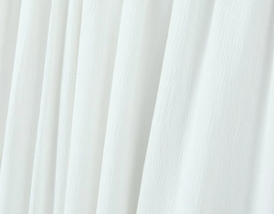 Close-up of lightweight white gauze fabric with a subtle textured weave and soft drape