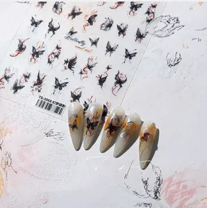 Detailed view of TS-3968 ink butterfly nail stickers on nude colored false nails