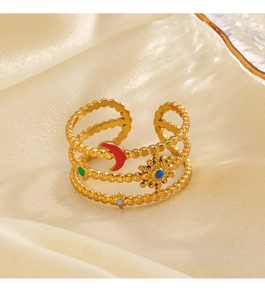 Detailed macro view of triple-layered gold celestial ring with colorful enamel accents