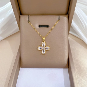 Luxurious gold clover necklace with sparkling cubic zirconia in a premium brown jewelry box