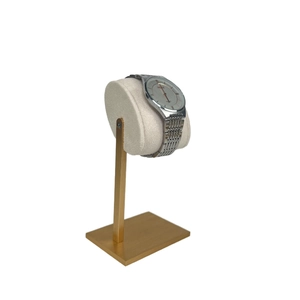 Champagne gold metal watch stand with beige velvet pillow for jewelry display