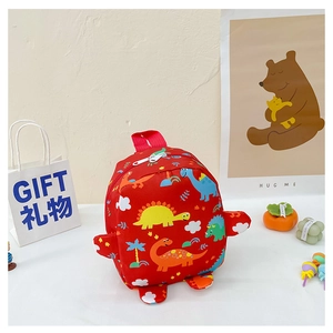 Close-up of red dinosaur backpack for kids with cute cartoon prints and zipper detail