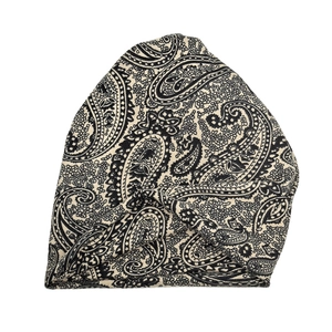 Close-up of paisley print knit beanie showing detailed pattern and soft fabric texture