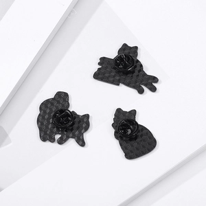 Three-piece set of cartoon cat enamel pins featuring a matte black honeycomb textured back