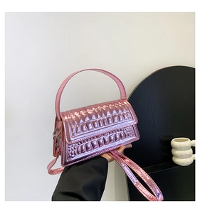 Detail of pink metallic handbag with embossed brick pattern and adjustable strap