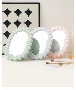 Pastel wave-frame desktop mirrors in pink, blue and green with chic vanity props