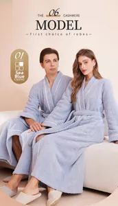 Detail of plush sea blue cashmere robe with white piping and matching waist belt
