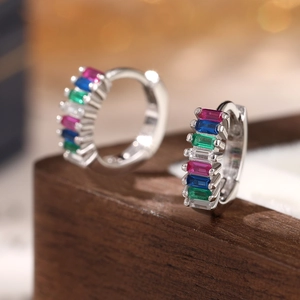 Macro shot of 925 silver hoop earrings with rectangular rainbow gemstones and hinge clasp