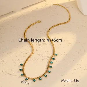 Detail of gold chain necklace with twelve green-blue water drop rhinestones and extension