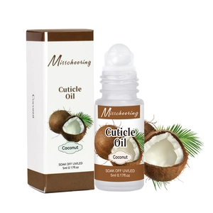 Detail view of 5ml coconut cuticle oil roller bottle with premium paper box packaging